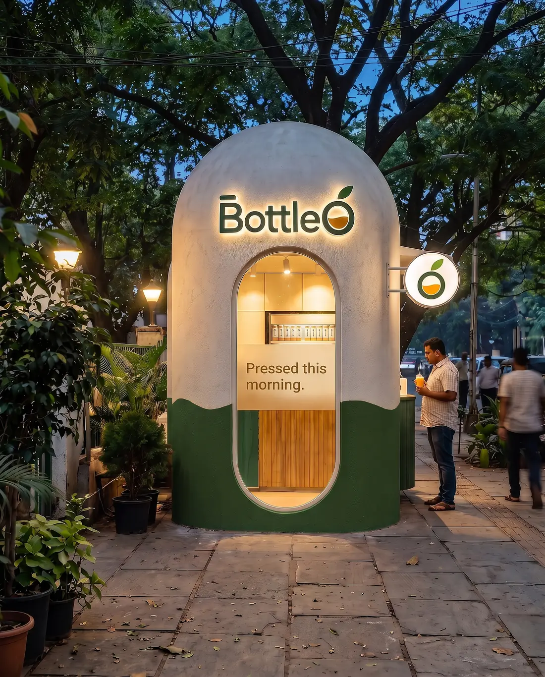 The BottleO capsule kiosk lit up at dusk in Indiranagar
